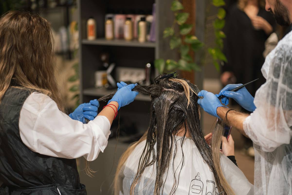 salon perm care showing freshly permed hair being gently combed with fingers